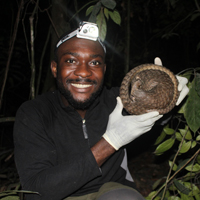 Photo of Charles Emogor holding a pangolin