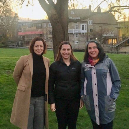 3 female postdocs standing near the millpond in Cambridge