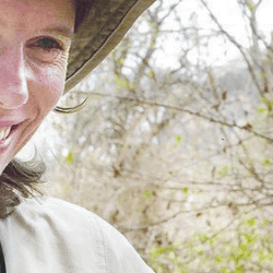 Prof Claire Spottiswoode FRS in the field with a honeyguide. 