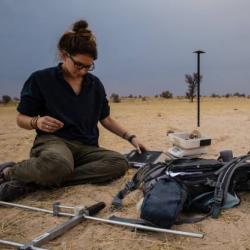 Studying meerkats in the desert.  (c) Tom Houslay